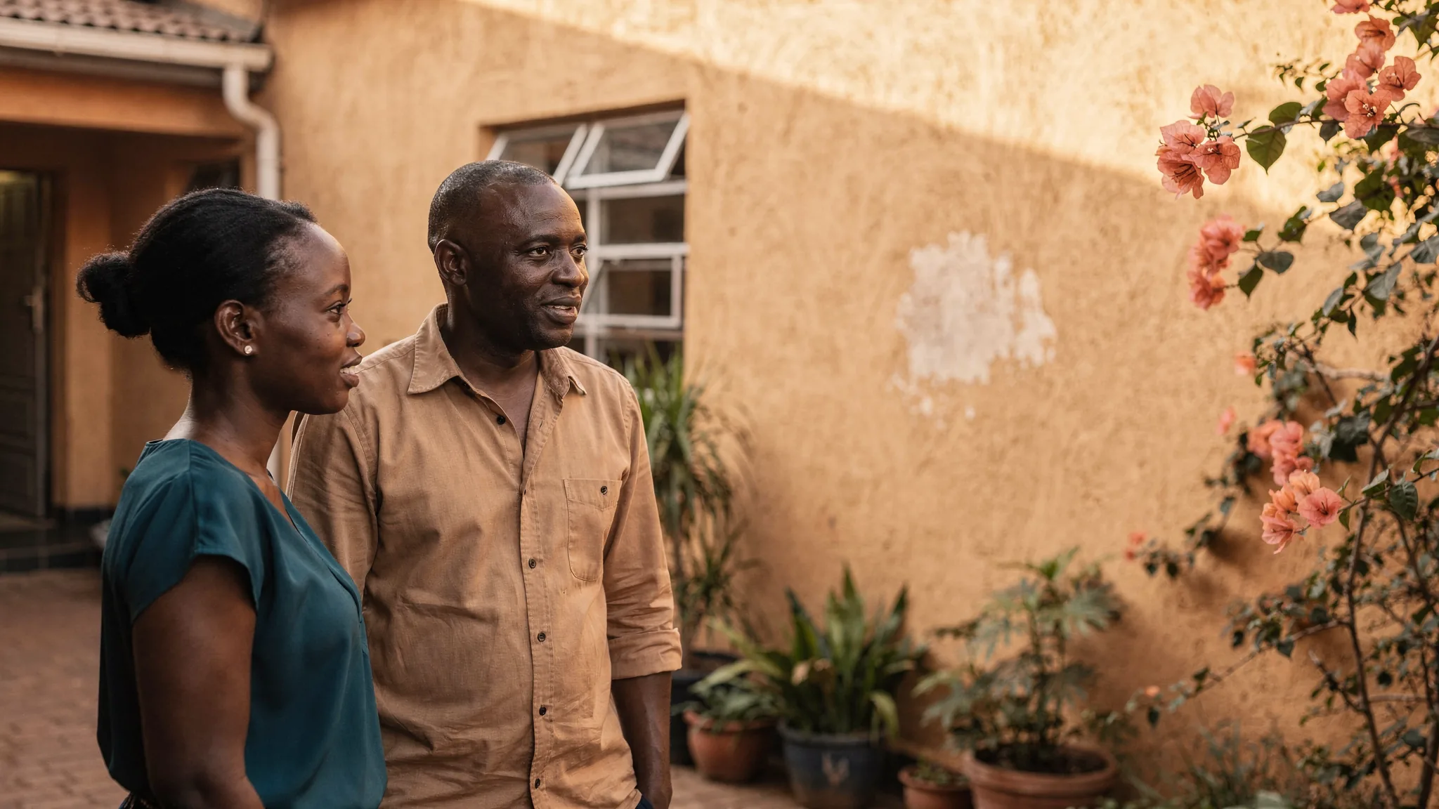 Two colleagues talking in a courtyard in Nairobi