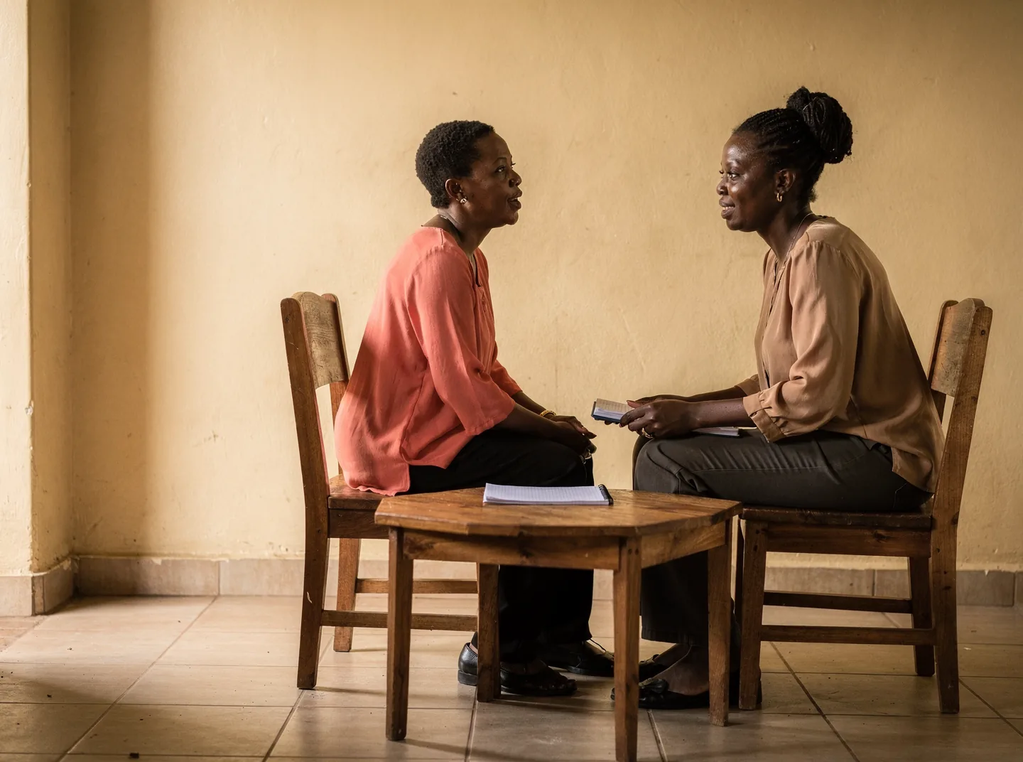 A counsellor and client talking in a consulting room